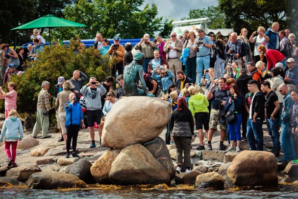 A horde of tourists take in the glory of The Little Mermaid statue.