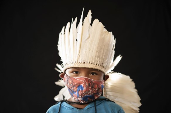 Six-year-old Ezinaldo dos Santos wears tribal dress and a Spiderman mask in Manaus, Brazil, in May.