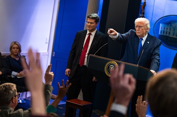 Trump takes questions as the US solicitor general, John Sauer, watches on.