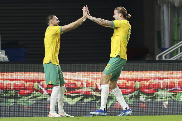 Jackson Irvine (right) celebrates with Martin Boyle.