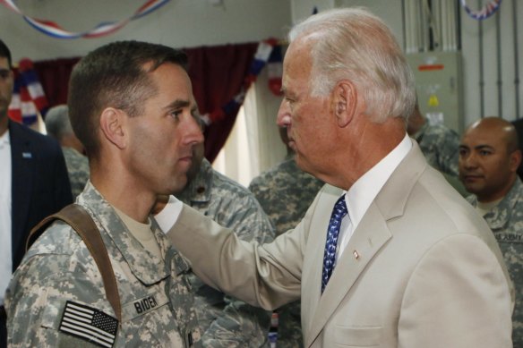 Joe Biden talking with then US Army Captain Beau Biden, at Camp Victory on the outskirts of Baghdad, Iraq in 2009. 