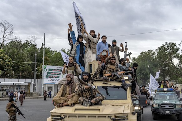 Taliban fighters celebrate one year since they seized the Afghan capital, in August 2022.