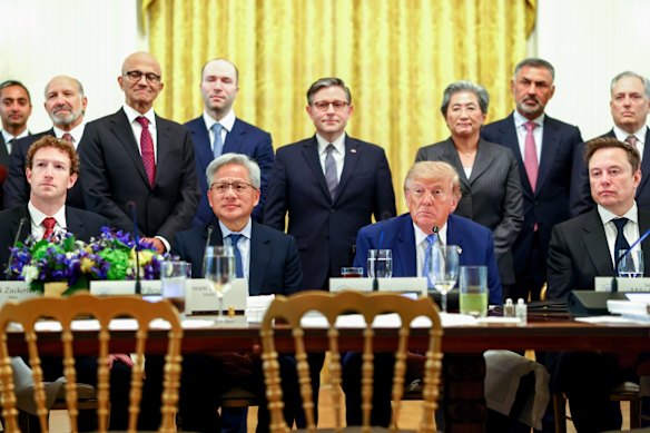 Donald Trump flanked by Nvidia boss Jensen Huang (on Trump’s left) and Elon Musk (right) with other tech executives, politicians and officials at the White House.