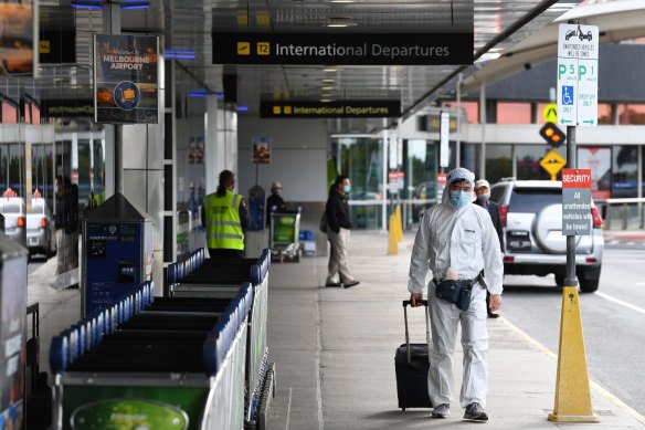 A man in personal protective equipment outside the international departures terminal at Melbourne Airport last week.