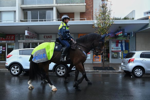 NSW Mounted Police patrol the streets of Fairfield during the lockdown. 