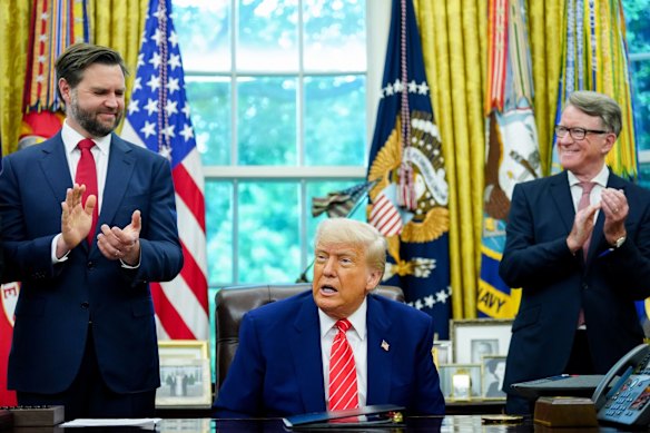 Vice President J.D. Vance, President Donald Trump and British ambassador Peter Mandelson applaud a trade deal between the UK and US.