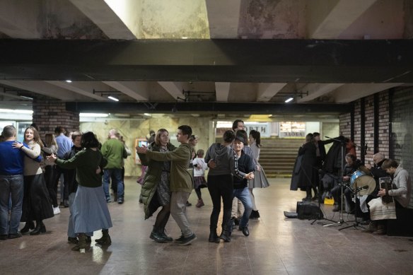 People dance in an underground passage during a missile alert in Kyiv.