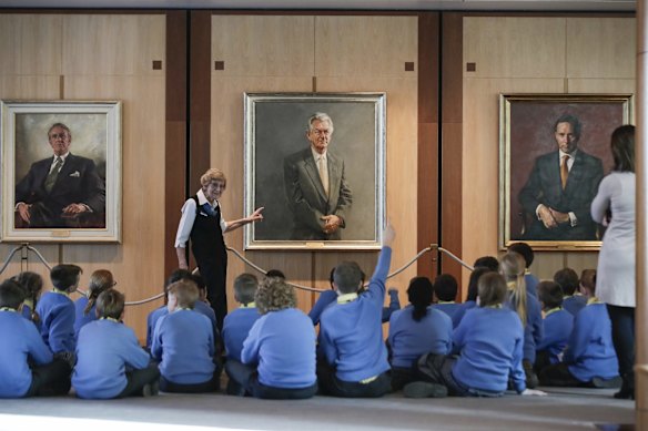 Civics education should be compulsory. Tour guide Gina Hall speaks to students in front of former PM Bob Hawke’s portrait during their tour of Parliament House.