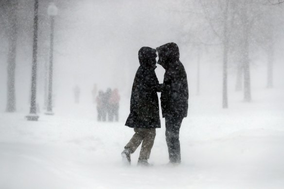 A couple walks through the snow on Boston Common, on Saturday, January 29.