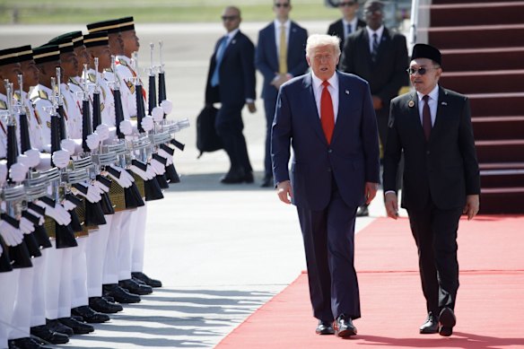 US President Donald Trump speaks with Anwar Ibrahim, Prime Minister of Malaysia, after arriving in Kuala Lumpur.