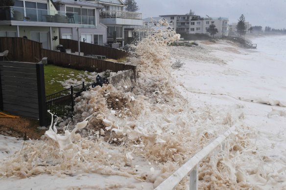 Sea foam whipped up by the strong surf inundates properties along Collaroy on Sydney's northern beaches.