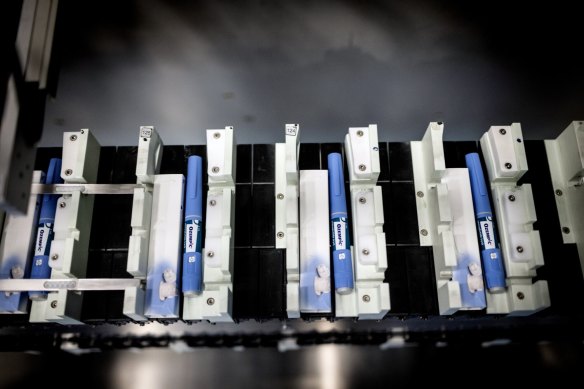 Ozempic injection pens move along a conveyor at a production facility.