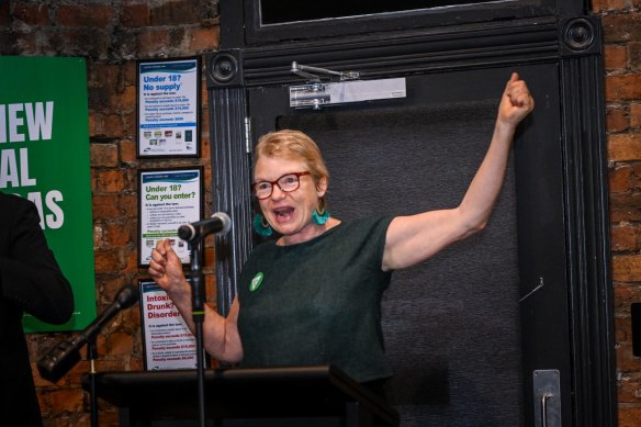 Greens Senator Janet Rice revs up the crowd of party volunteers by declaring the party had won the seats of Melbourne and Brunswick.