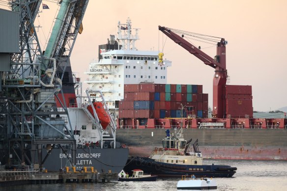 A cargo ship loaded with shipping containers docked in the Port of Newcastle at Dyke Wharf berth. 