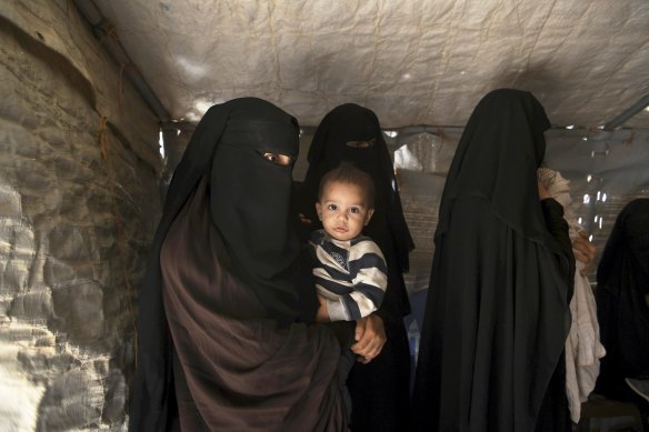 Australian mother Zahra Ahmed (left) holding her son Ibrahim (2nd from left) in al-Hawl camp in north-east Syria, October 2019.