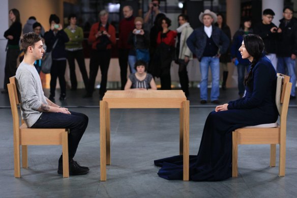 Marina Abramovic and a visitor perform <i>The Artist is Present</i> in New York.