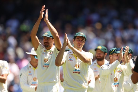 Pat Cummins, right, applauds the crowd after winning the third test.