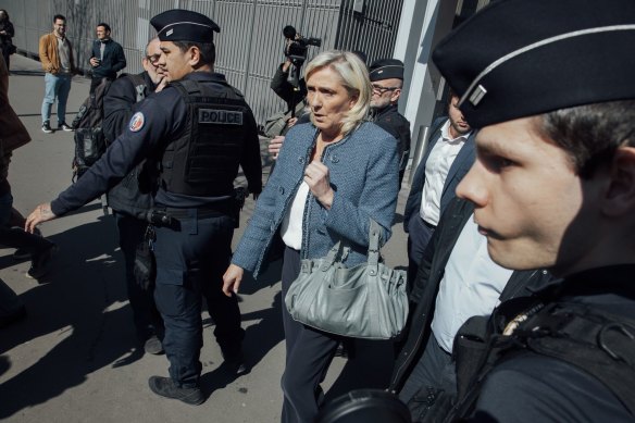 Marine Le Pen, leader of National Rally, leaves the court in Paris after the ruling.
