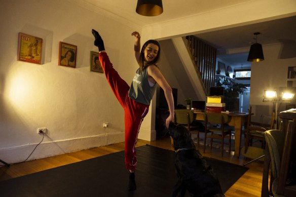 Sydney Dance Company Dancer Mia Thompson with her dog Pepe in her living room.