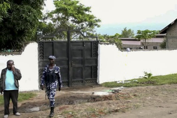 security forces are seen outside the gate of the Lhubiriha Secondary School following an attack.