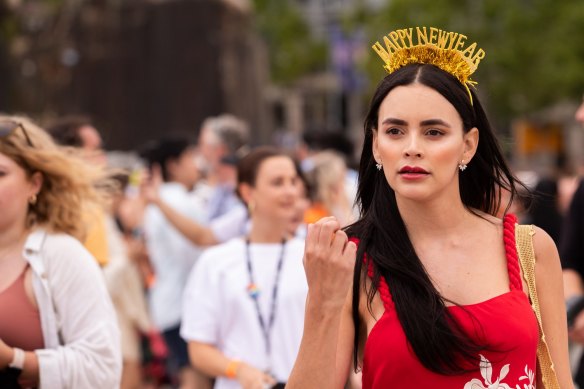 A woman dressed for New Years Eve, walks through the forecourt of the Sydney Opera House. Photo by Cole Bennetts NYE Dec 31, 2022. SMH