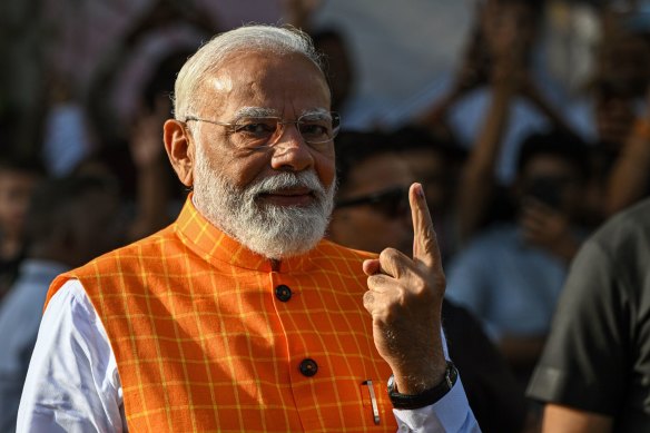 Prime Minister Narendra Modi shows his finger marked with indelible ink after casting a ballot on May 7 during the third phase of voting for national elections in Ahmedabad, Gujarat, India.