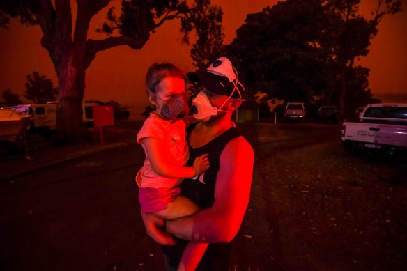 The sky in Mallacoota turned blood red on January 4, when a south-westerly wind change flared up flames. Mike and his daughter Elsie were still trapped in the tiny coastal town five days after the first fire ripped through. 