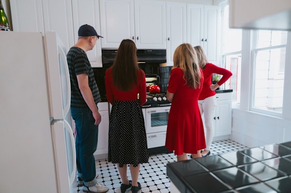 A group of strangers stand in a kitchen imagining what it might be like to own this house.
