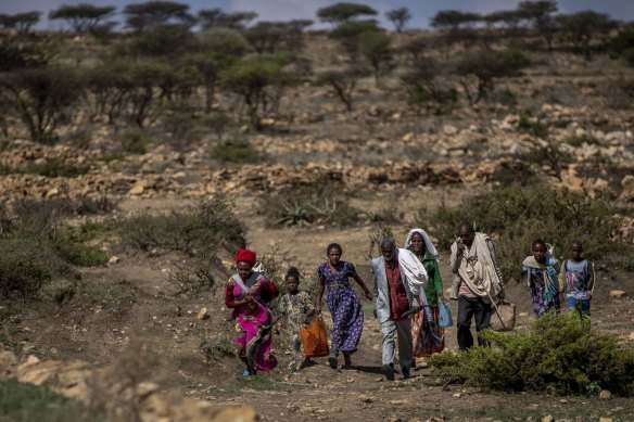 People walk from a rural area to a charity food distribution point near the town of Agula, in the Tigray region of northern Ethiopia, last month.