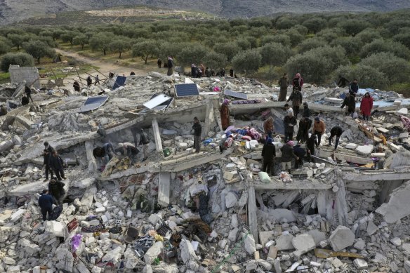 Syria’s opposition Civil Defence workers and residents search through the rubble of collapsed buildings in the town of Harem near the Turkish border, Idlib province, on Monday.