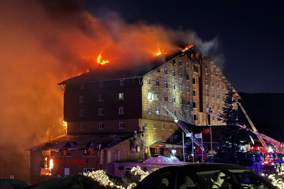 Firefighters work to extinguish the fire in a hotel at a ski resort of Kartalkaya in Bolu province, in north-west Turkey.
