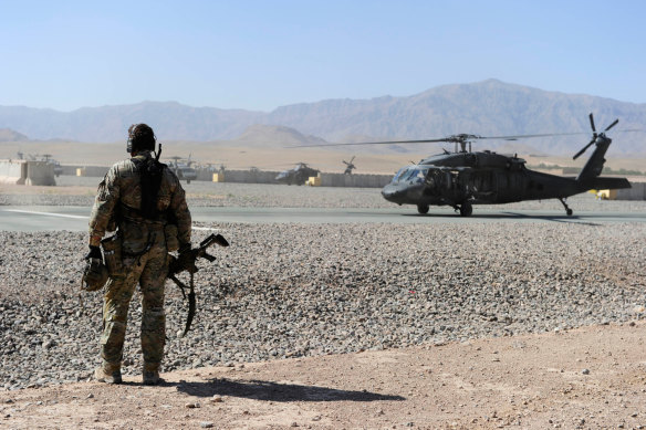 An SAS soldier awaits the arrival of a UH-60 Blackhawk helicopter in Afghanistan.