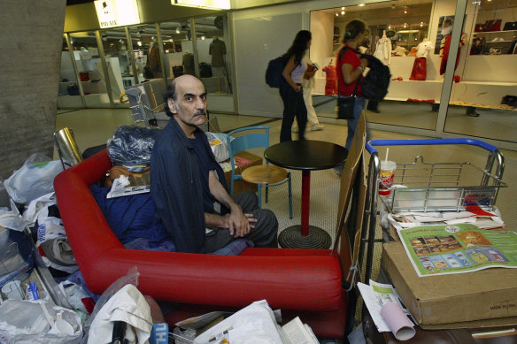 Merhan Karimi Nasseri sits among his belongings at Terminal 1 of Roissy Charles De Gaulle Airport, north of Paris on August 11, 2004.