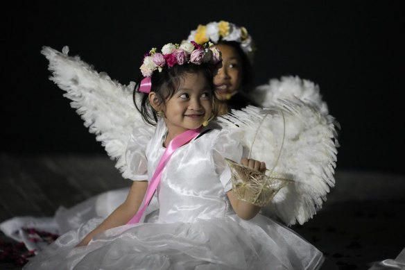 Girls dressed as angels smile during Easter Sunday rites in the Philippines in 2023.