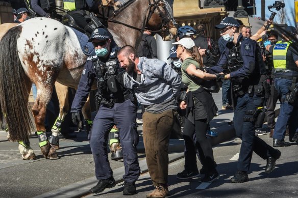 Police and protesters clash on Spring Street during Saturday’s anti-lockdown rally.