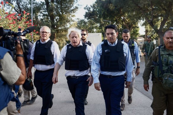 Former Australian Prime Minister Scott Morrison and former UK Prime Minister Boris Johnson visit an area destroyed during fighting with Hamas militants.