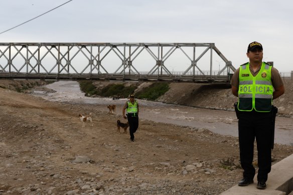 Police officers guard the provisional bridge connecting to the new airport.