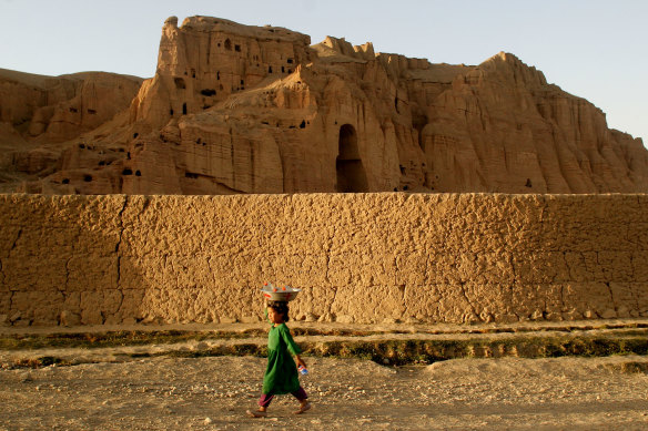 A girl in Bamiyan, Afghanistan passes the void where a giant 6th-century statue of Buddha stood before its destruction by the Taliban. Countless items of the region’s heritage have been destroyed or smuggled out during decades of conflict.