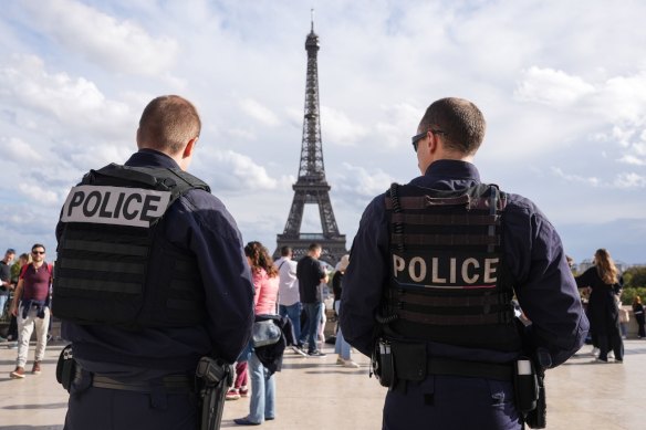 French police officers patrol near the Eiffel Tower in October.