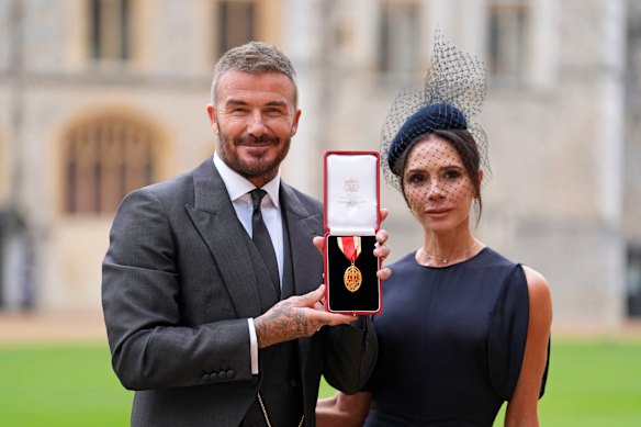 Sir David Beckham, with his wife Lady Victoria, after being made a Knight Bachelor.