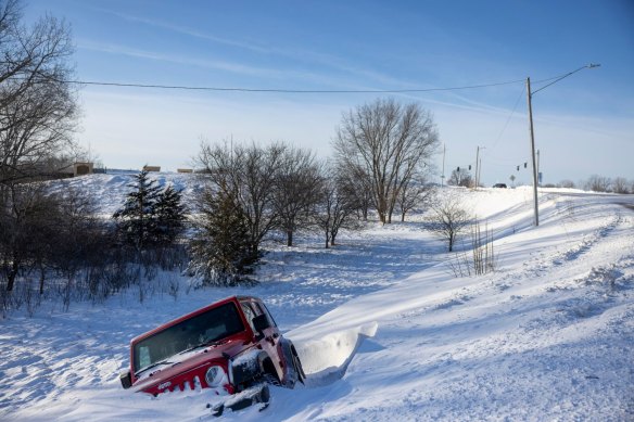 A vehicle off an embankment during a winter storm ahead of the Iowa caucus.