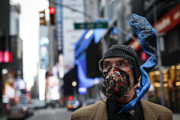 Performance artist Lynx Alexander walks through Times Square wearing a customised breathing mask in response to the spread of COVID-19.