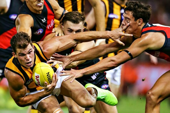 Hawthorn’s Jaeger O’Meara shrugs off the Bombers. 