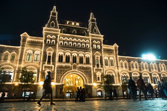People walk past the GUM Department store in Moscow, Russia. 