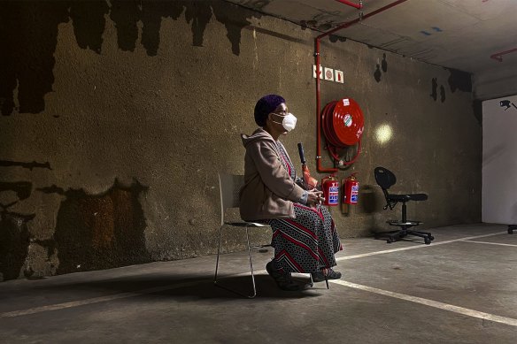 A woman waits to be tested for COVID-19 in a shopping centre car park in Johannesburg.