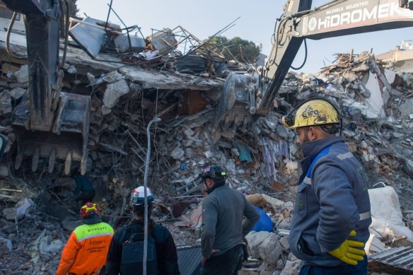 Volunteers work on rescue operations at the site of a collapsed building in Hatay, Turkey.