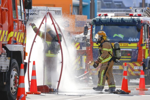 Firefighters rinse off after a fire at Loafers Lodge.