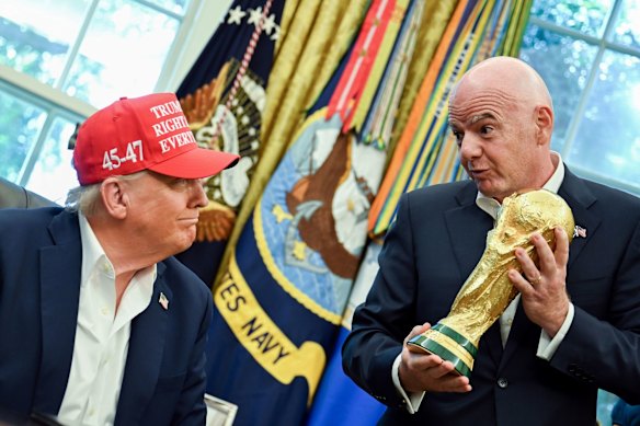US President Donald Trump, left, and Gianni Infantino, president of FIFA, with the World Cup trophy in the Oval Office.