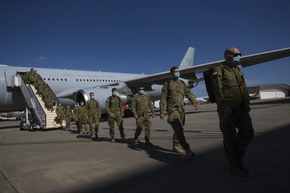 A contingent of ADF personnel arrive in Melbourne from Townsville in December.