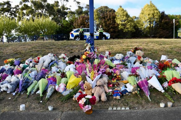 Flowers blanket the front lawn of Hillcrest Primary School following the tragedy.